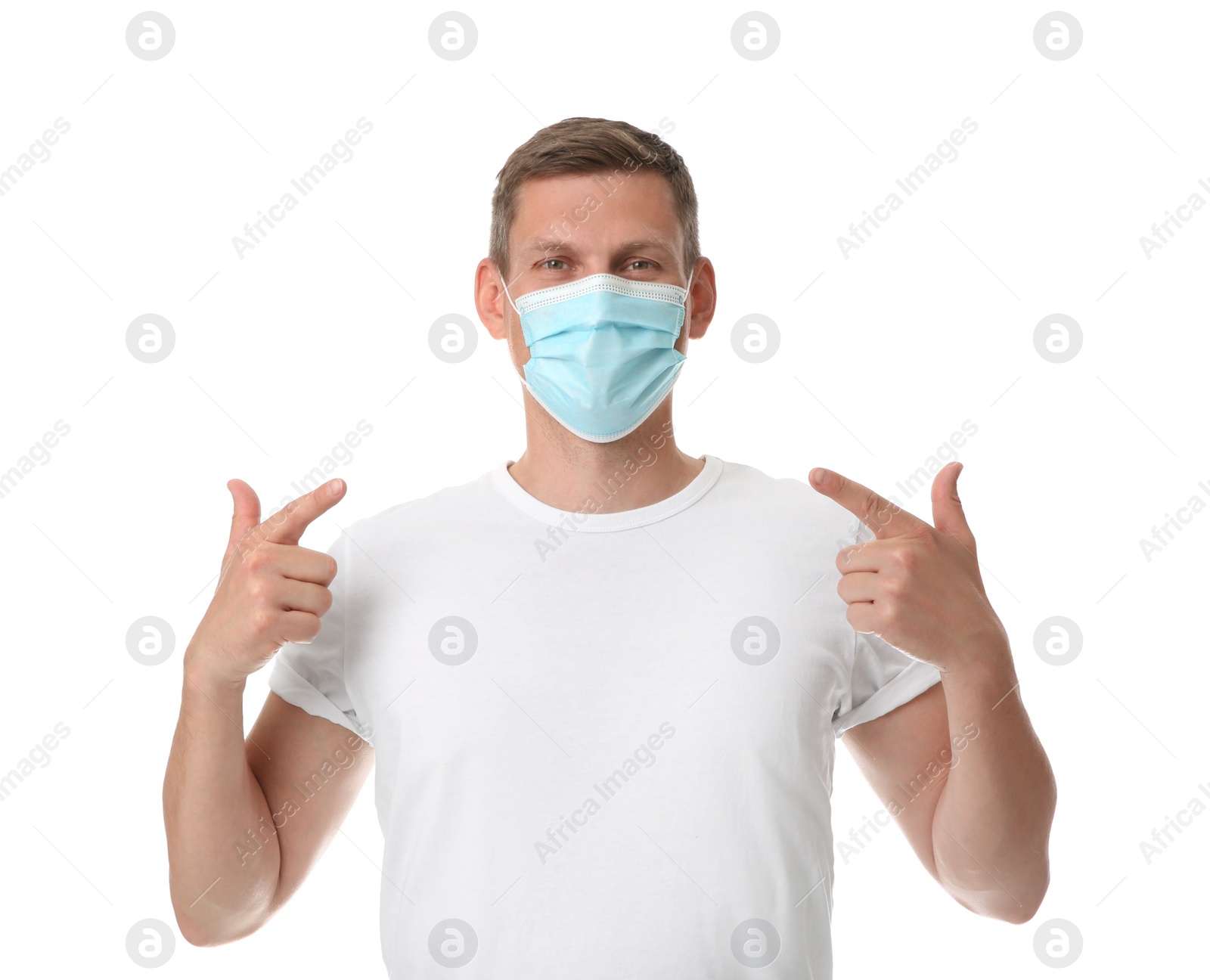 Photo of Male volunteer in mask on white background. Protective measures during coronavirus quarantine