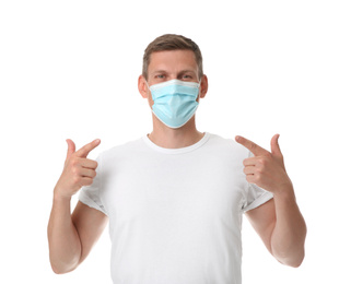 Photo of Male volunteer in mask on white background. Protective measures during coronavirus quarantine