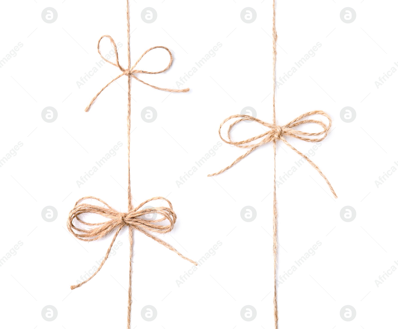 Photo of Linen rope strings with bows isolated on white, top view