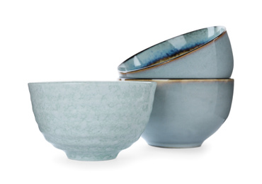 Photo of New beautiful ceramic bowls isolated on white