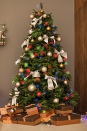 Photo of Beautiful Christmas tree and gift boxes in room