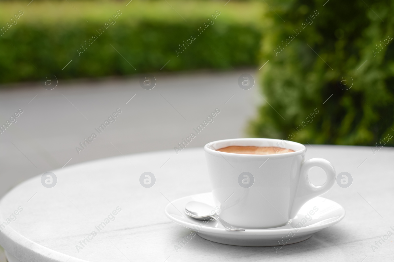 Photo of Ceramic cup of aromatic coffee on table in morning, space for text