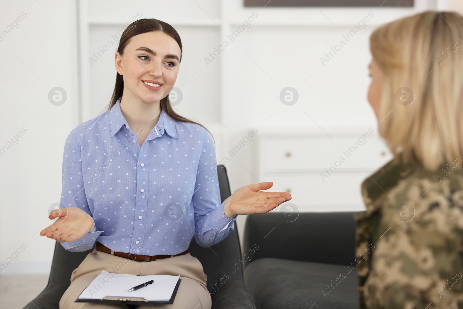 Photo of Psychotherapist working with military woman in office