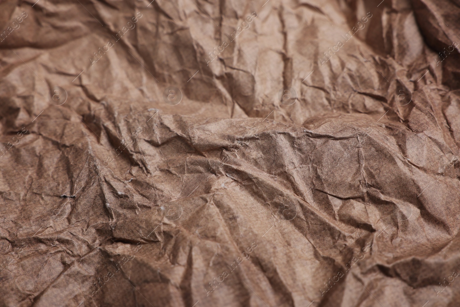 Photo of Texture of crumpled parchment paper as background, closeup