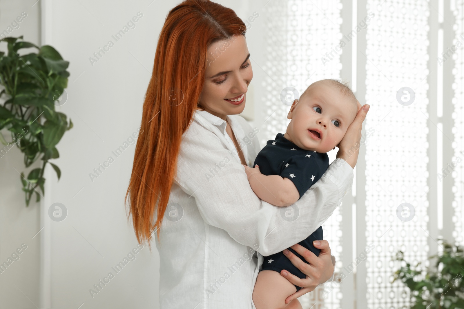 Photo of Mother with her cute baby at home