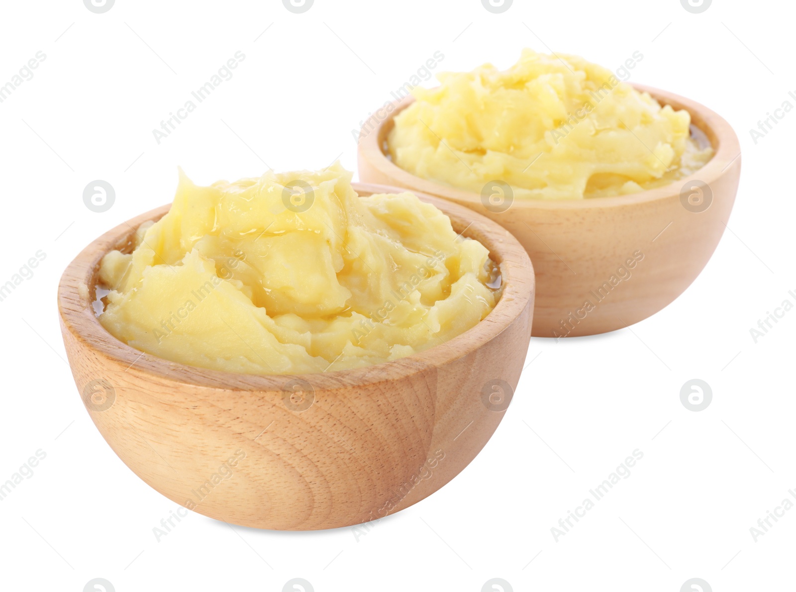 Photo of Bowls of tasty mashed potato isolated on white