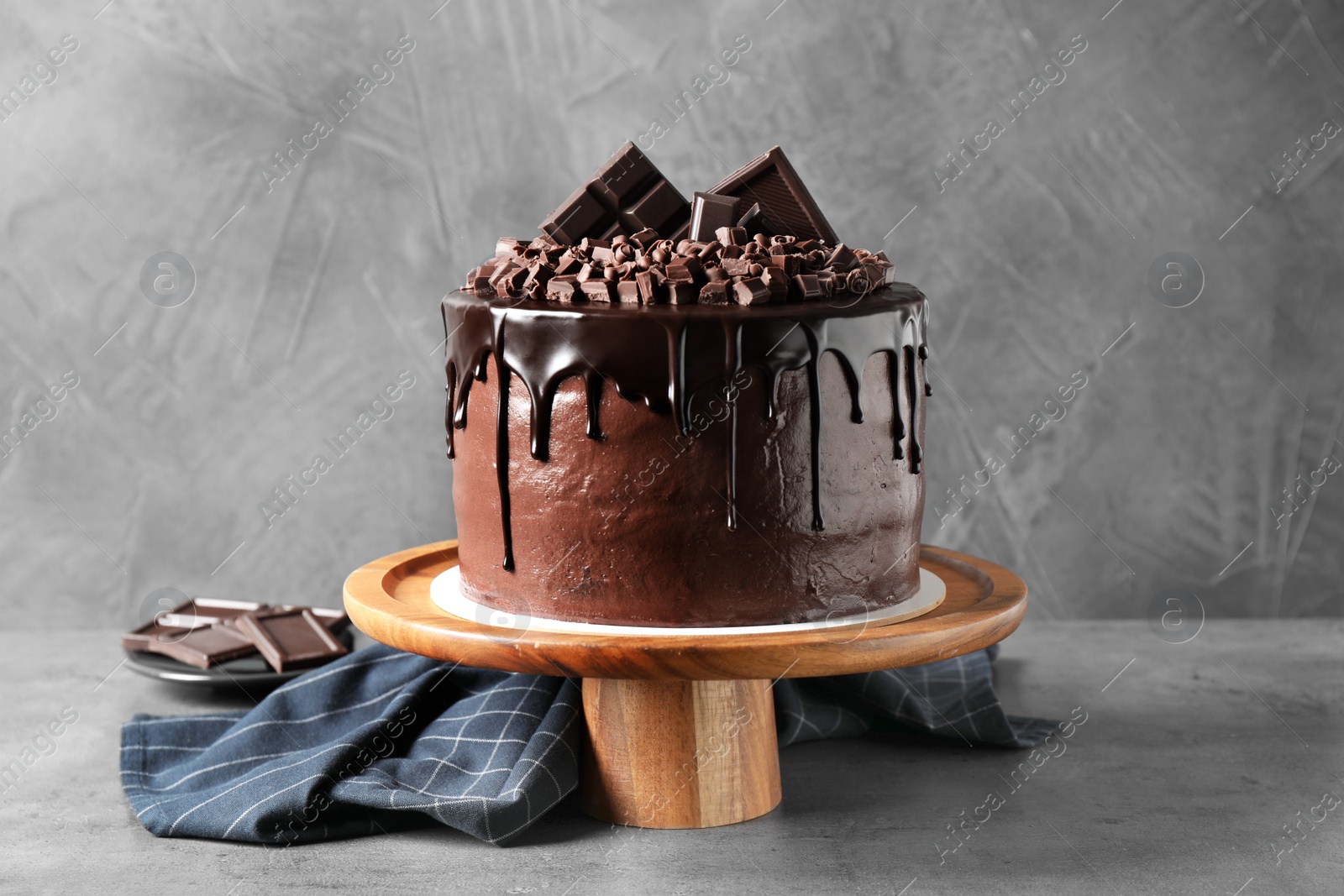 Photo of Freshly made delicious chocolate cake on grey table