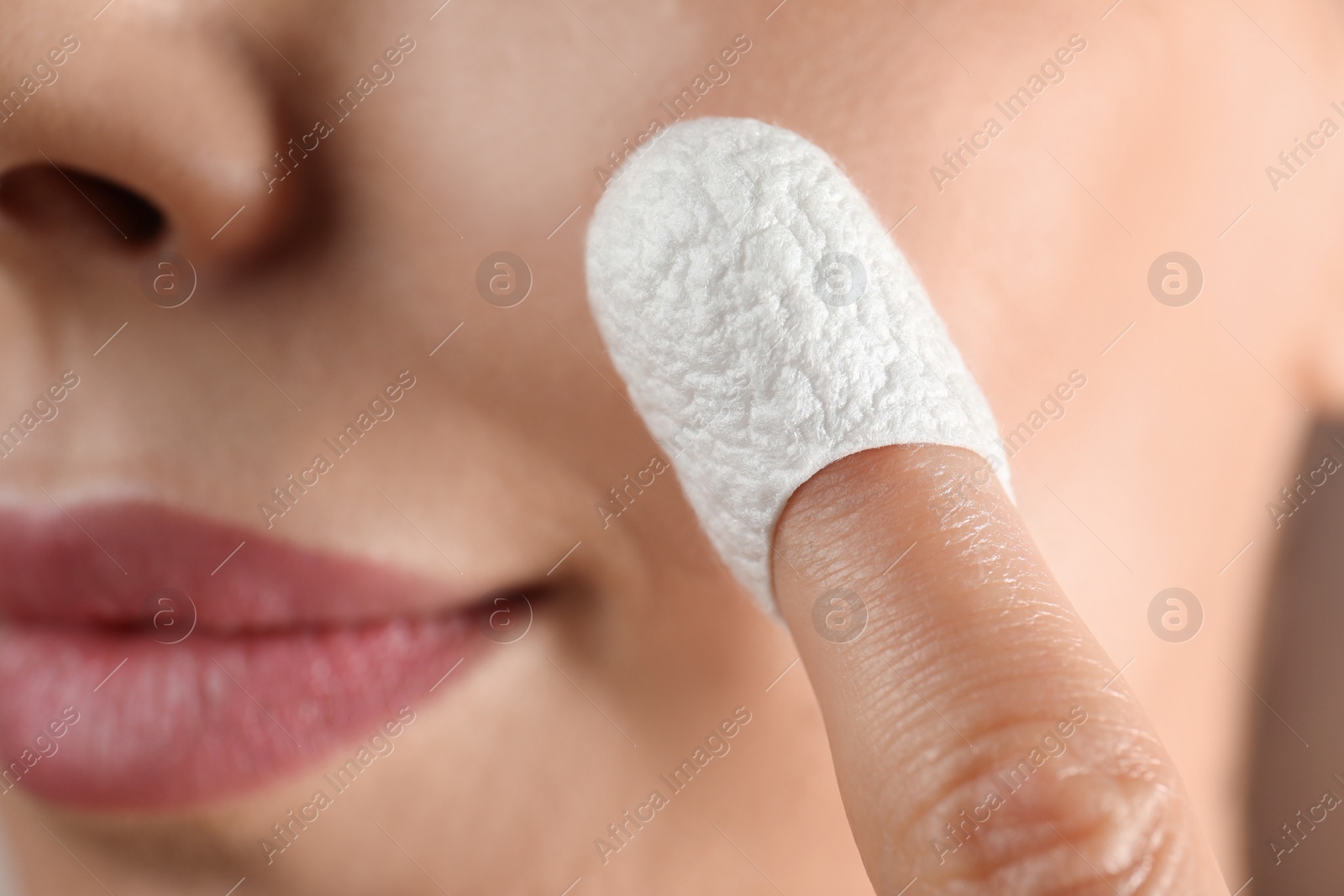 Photo of Woman using silkworm cocoon in skin care routine, closeup