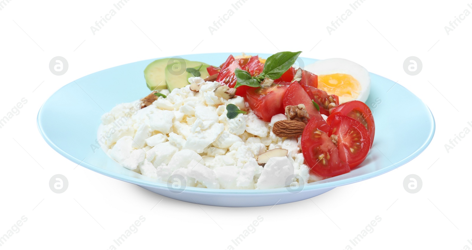 Photo of Plate of fresh cottage cheese with vegetables and egg isolated on white