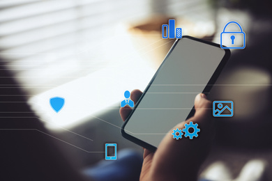 Image of Information security. Young man using smartphone indoors, closeup