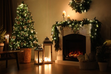 Photo of Beautiful room interior with fireplace and Christmas decor in evening