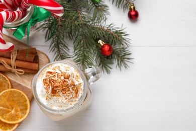 Flat lay composition with delicious Christmas liqueur on white table, space for text