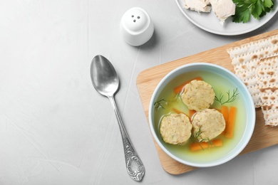 Flat lay composition with Jewish matzoh balls soup on light table. Space for text