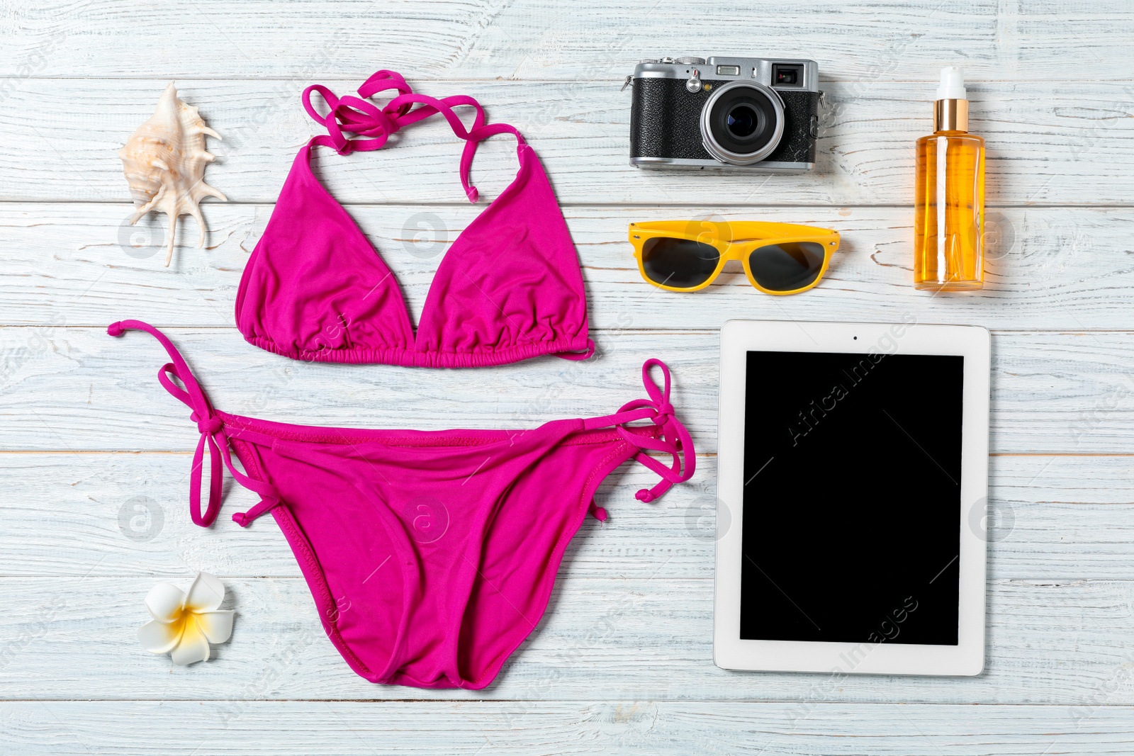 Photo of Flat lay composition with beach objects and tablet on wooden background