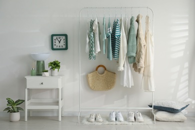 Photo of Dressing room interior with clothing rack and nightstand