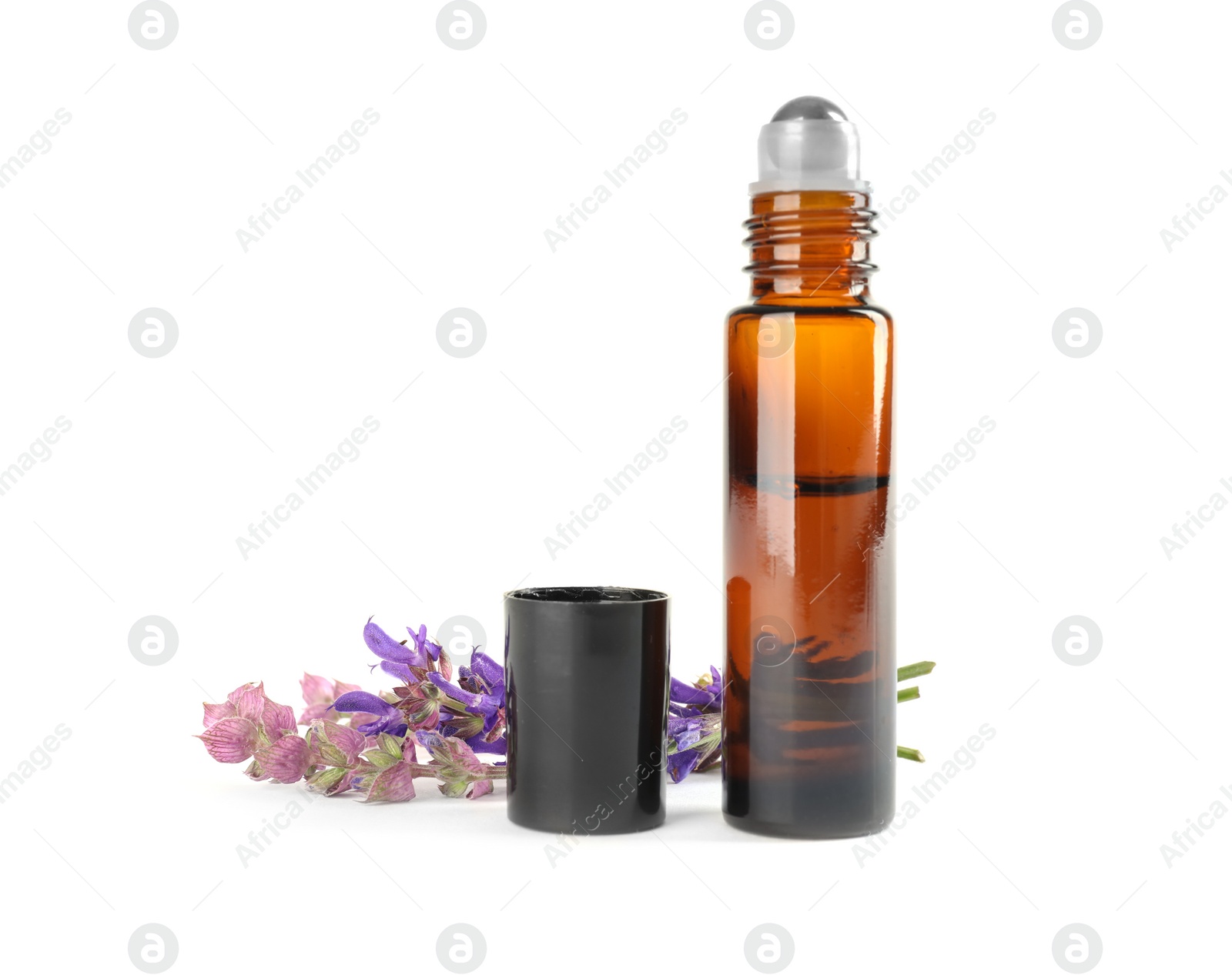 Photo of Bottle of herbal essential oil and sage flowers isolated on white