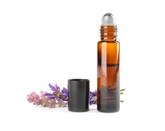 Photo of Bottle of herbal essential oil and sage flowers isolated on white