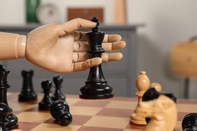 Photo of Robot moving chess piece on board, closeup. Wooden hand representing artificial intelligence