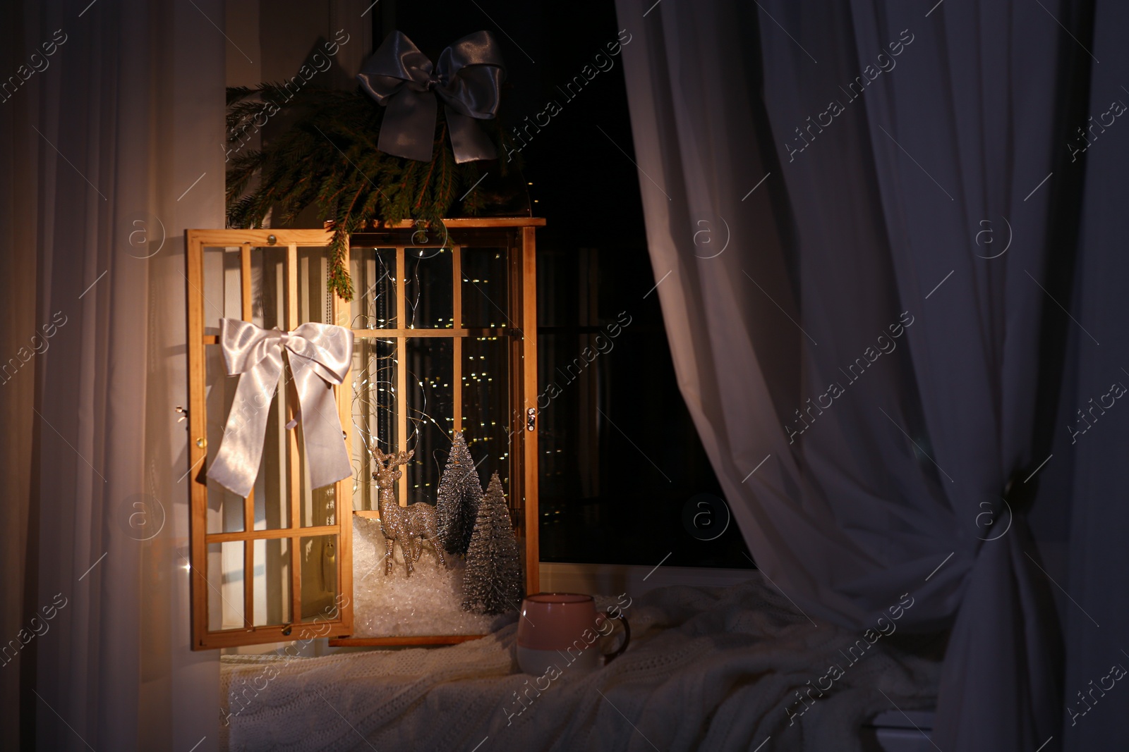 Photo of Vintage wooden lantern with beautiful Christmas composition on window sill indoors