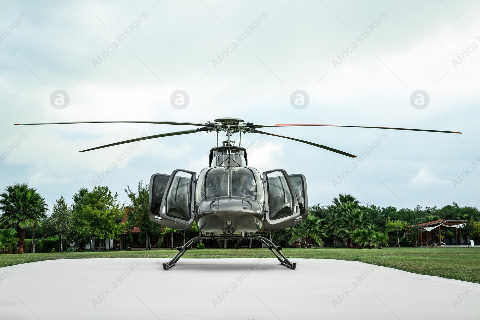 Photo of Beautiful modern helicopter on helipad in field