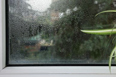 Photo of Window glass with water drops, view from inside