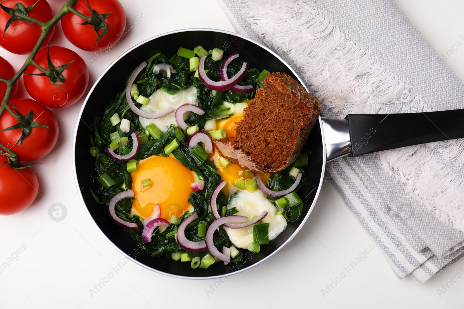 Photo of Tasty shakshuka with piece of bread isolated on white table, flat lay