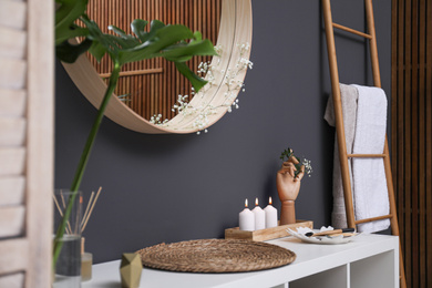 Photo of Elegant modern bathroom with mirror on black wall