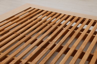 Photo of Closeup view of new wooden bed frame indoors