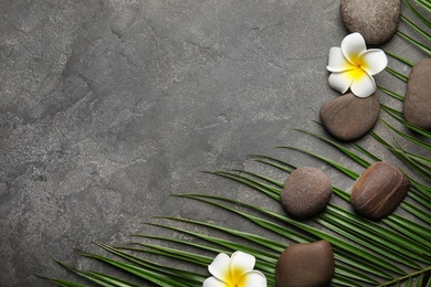 Photo of Flat lay composition with stones on grey background, space for text. Zen concept