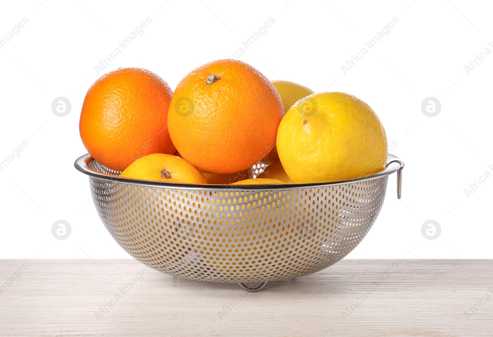 Photo of Fresh fruits in colander on wooden table against white background