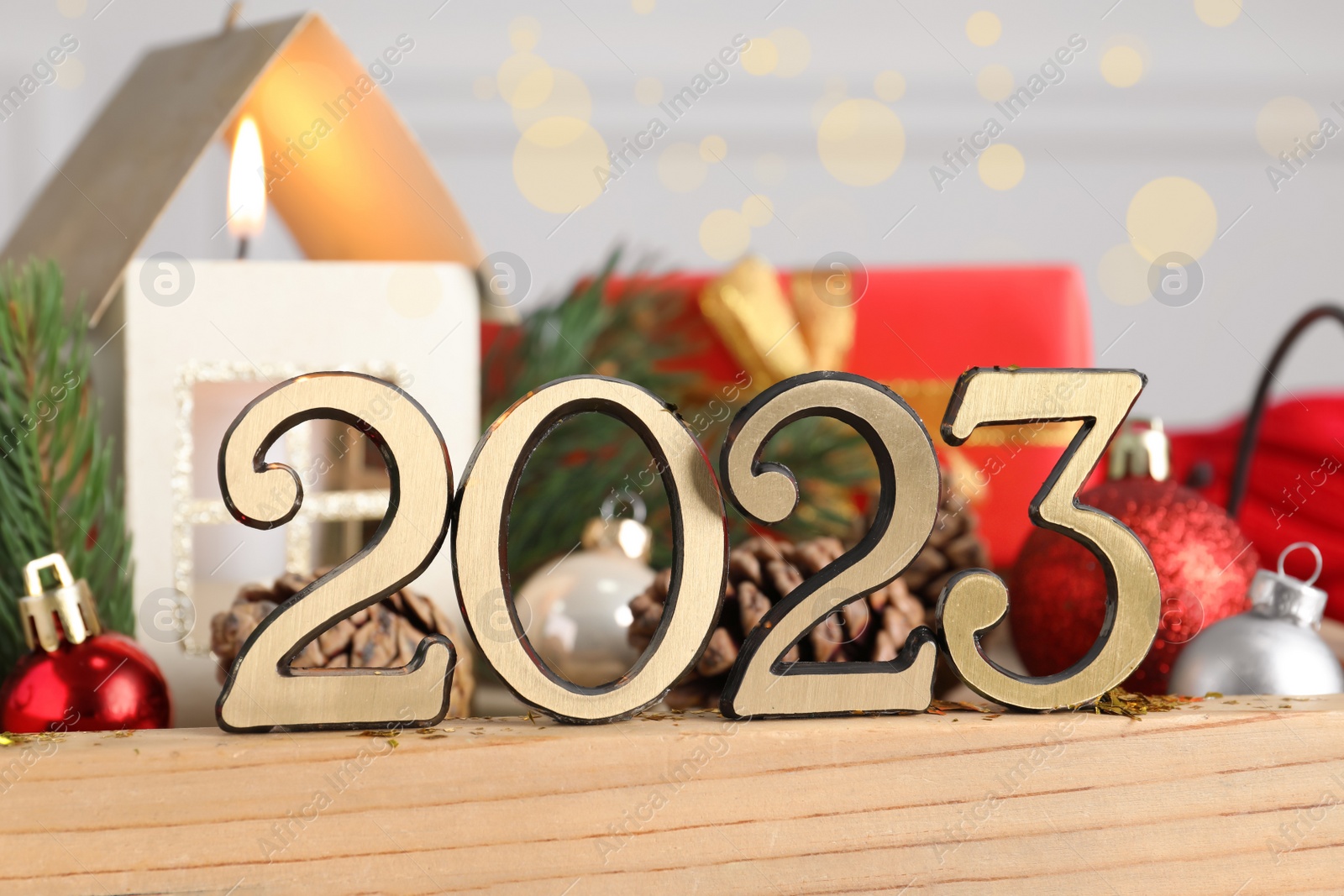 Photo of Number 2023 and festive decor on wooden tray, closeup. Happy New Year