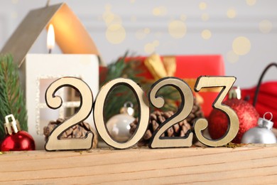 Number 2023 and festive decor on wooden tray, closeup. Happy New Year