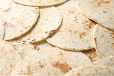 Photo of Many tasty homemade tortillas as background, closeup
