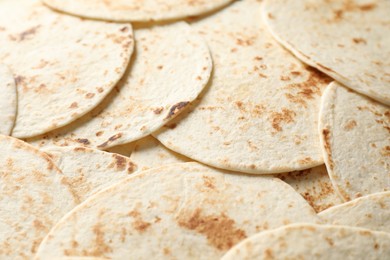 Many tasty homemade tortillas as background, closeup