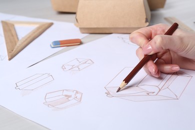 Photo of Woman creating packaging design at light table, closeup