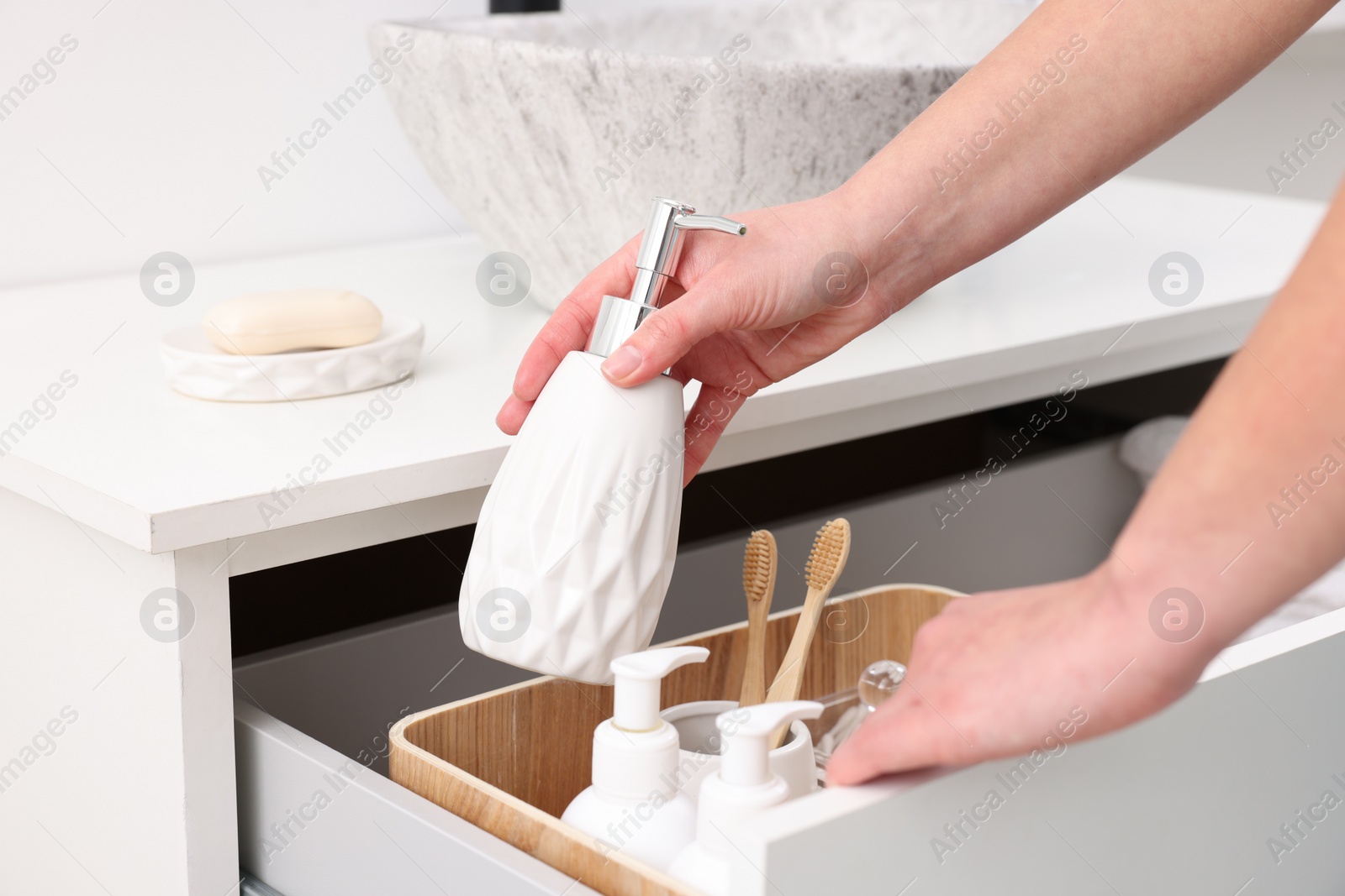 Photo of Bath accessories. Woman with container of cosmetic product indoors, closeup