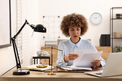 Notary working with documents at workplace in office