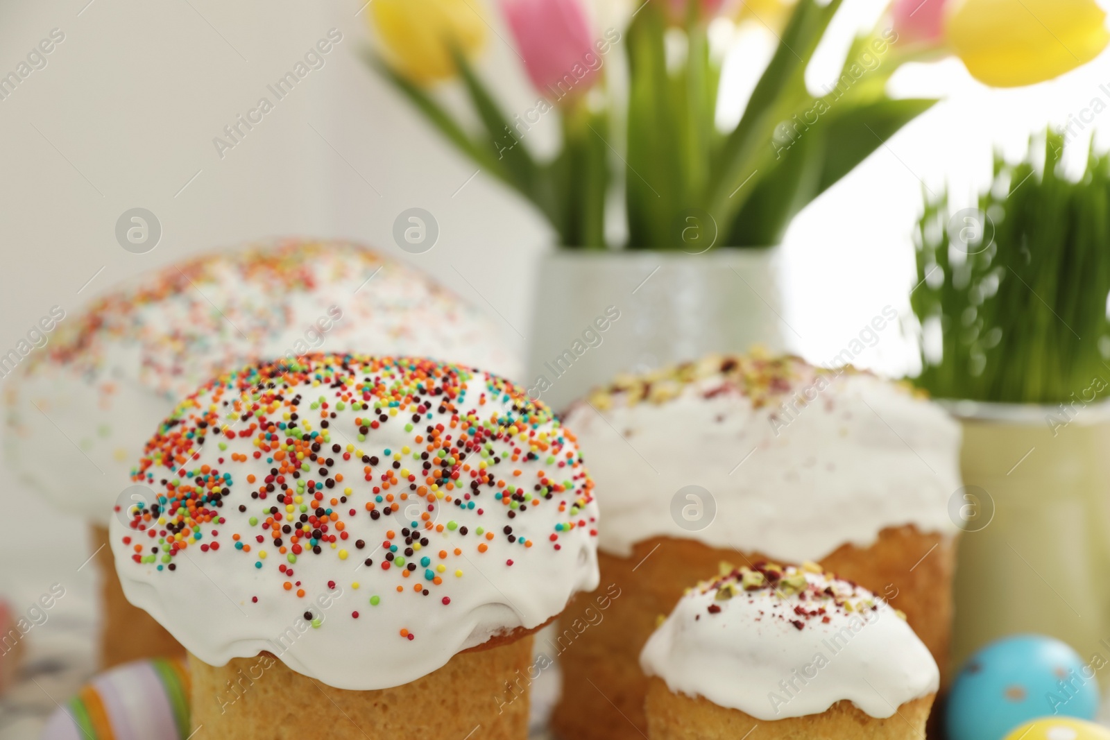 Photo of Traditional Easter cakes on blurred background, closeup