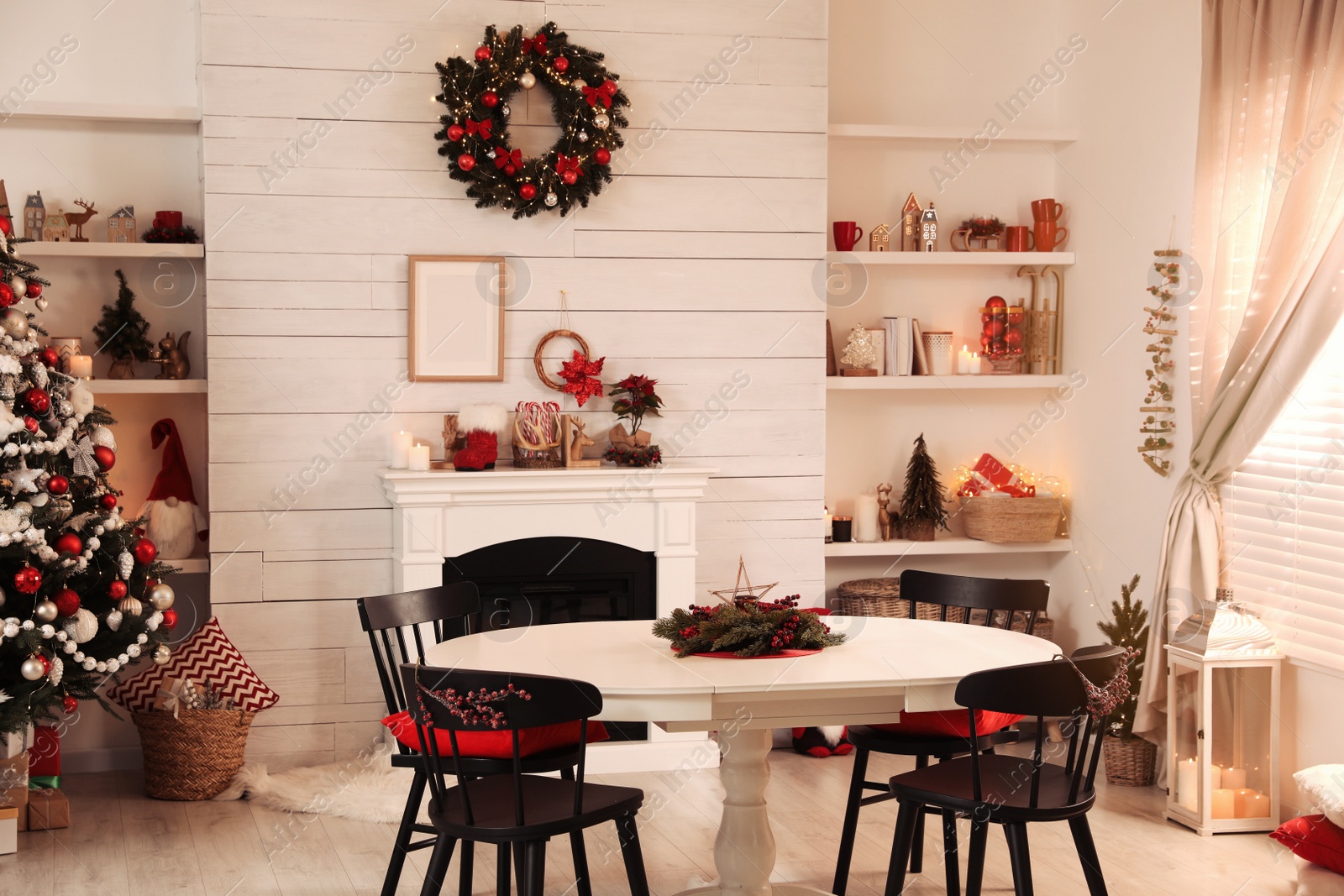 Photo of Cozy dining room interior with Christmas tree and festive decor