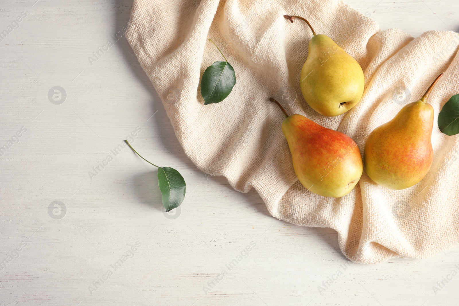 Photo of Flat lay composition with ripe pears on white wooden background. Space for text