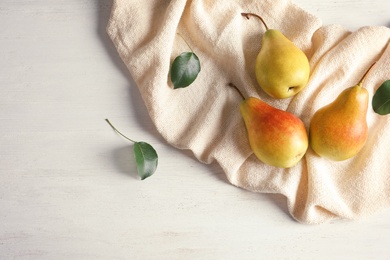 Photo of Flat lay composition with ripe pears on white wooden background. Space for text