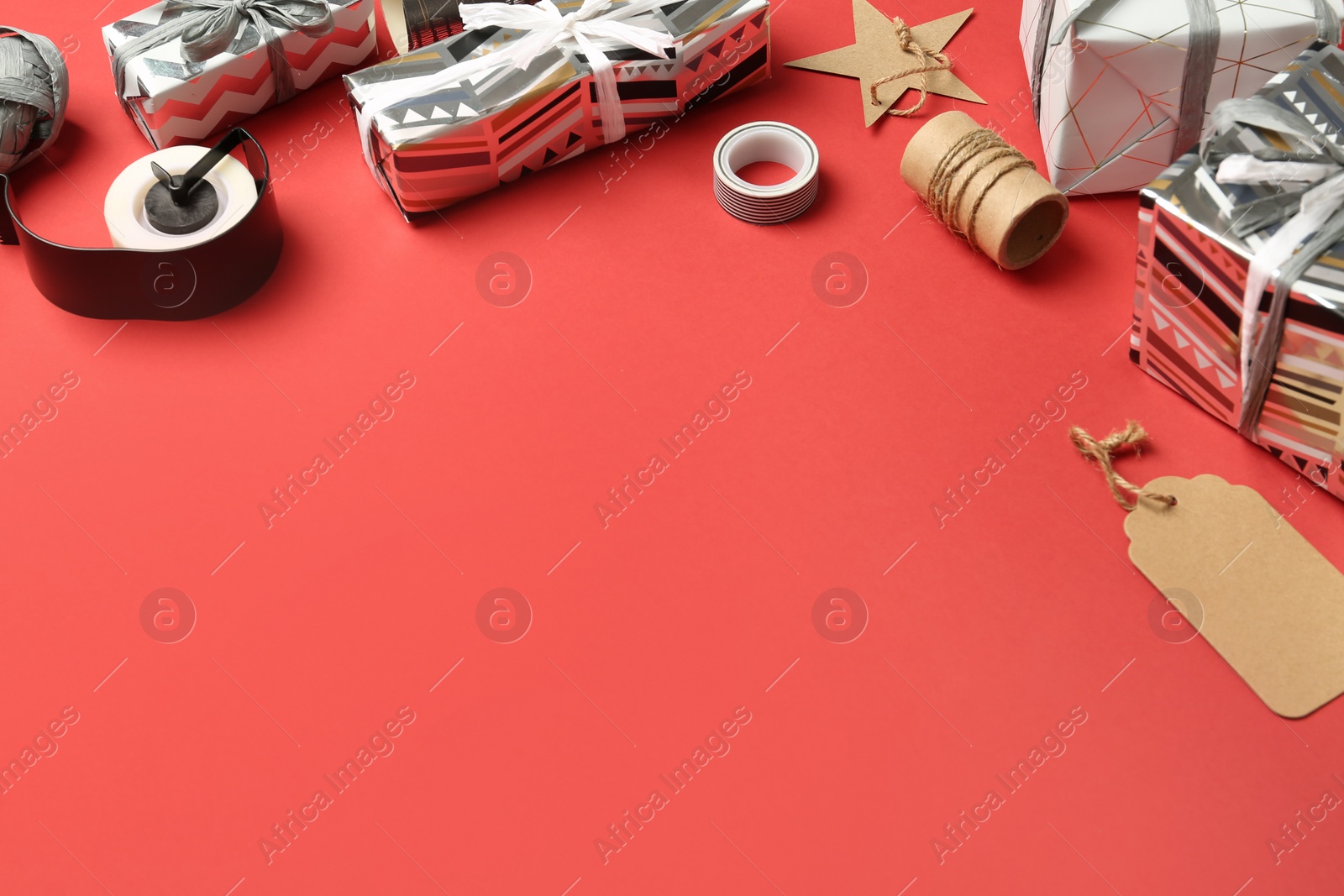 Photo of Beautiful gift boxes and tools for decor on color background. Space for text