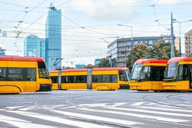 Photo of Modern trams on city street. Public transport