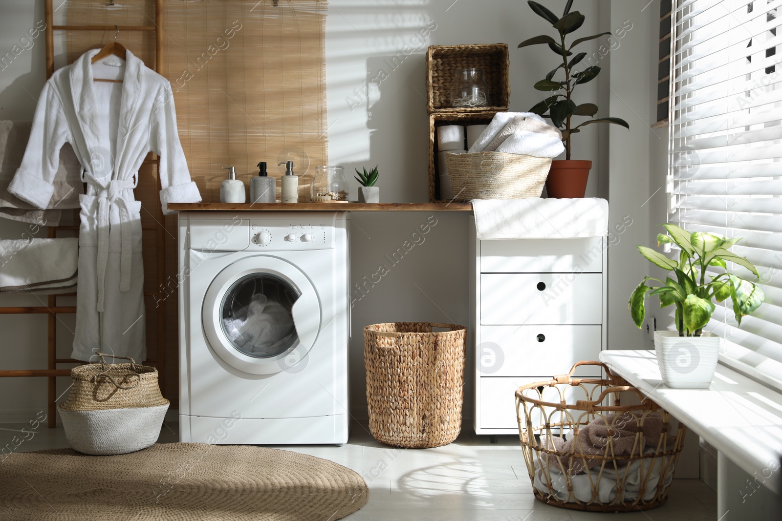 Photo of Stylish bathroom interior with modern washing machine