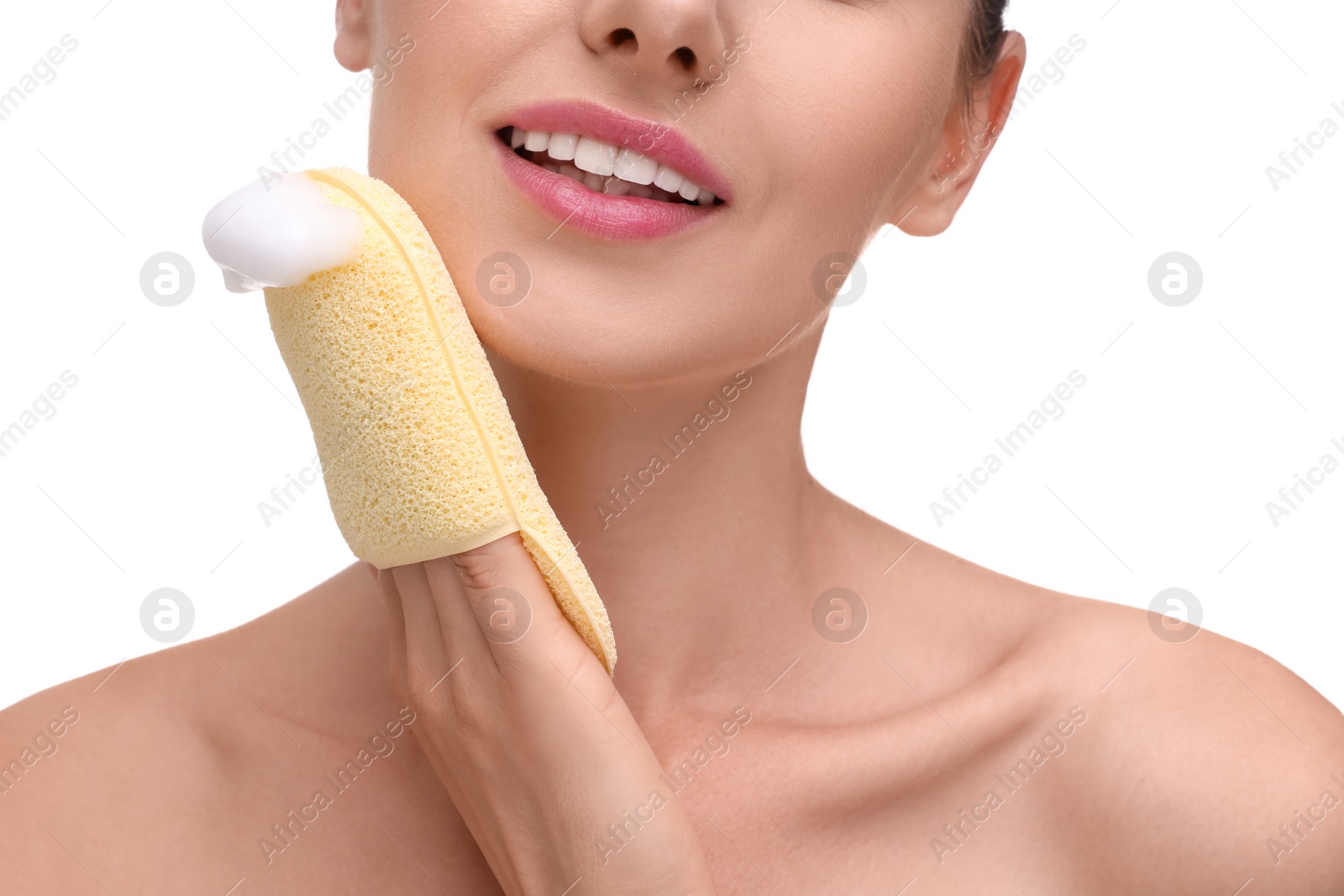 Photo of Happy young woman washing her face with sponge on white background, closeup