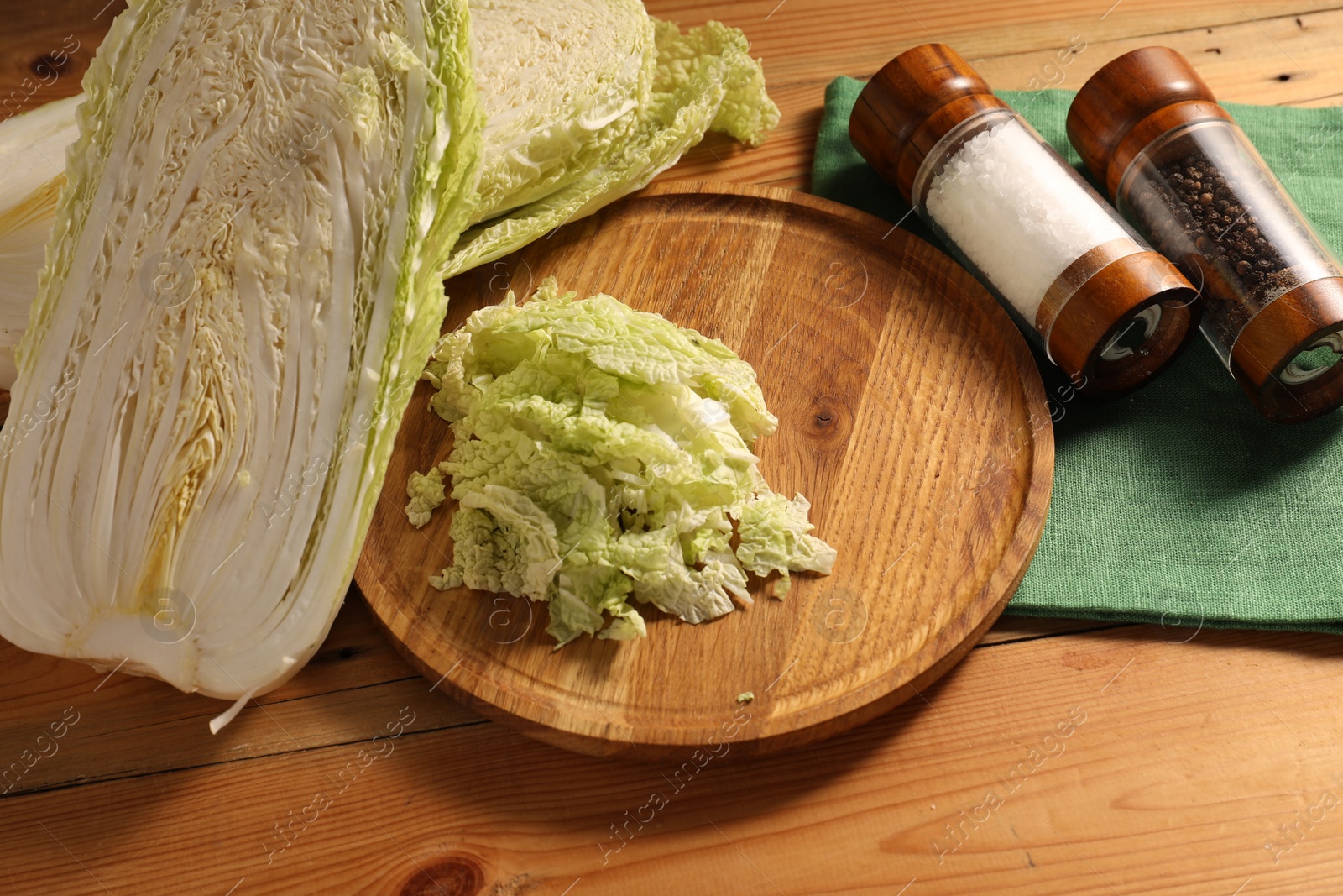 Photo of Fresh Chinese cabbage and spices on wooden table