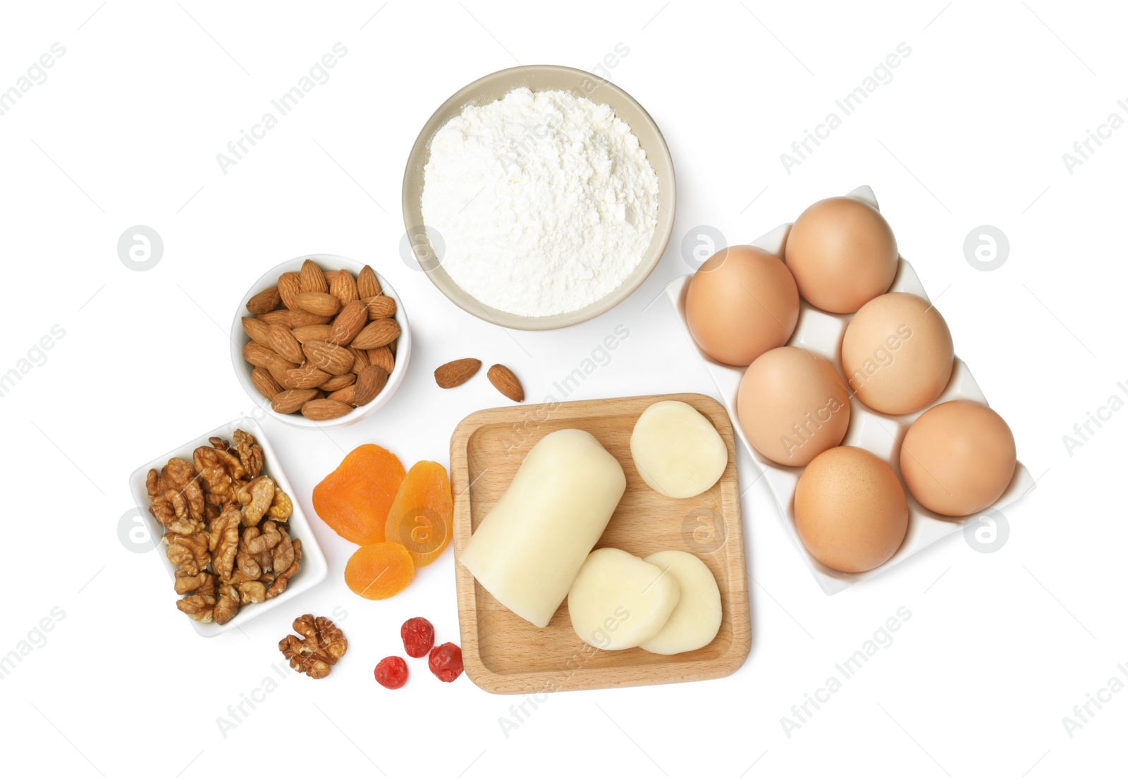 Photo of Marzipan and other ingredients for homemade Stollen on white background, top view. Baking traditional German Christmas bread