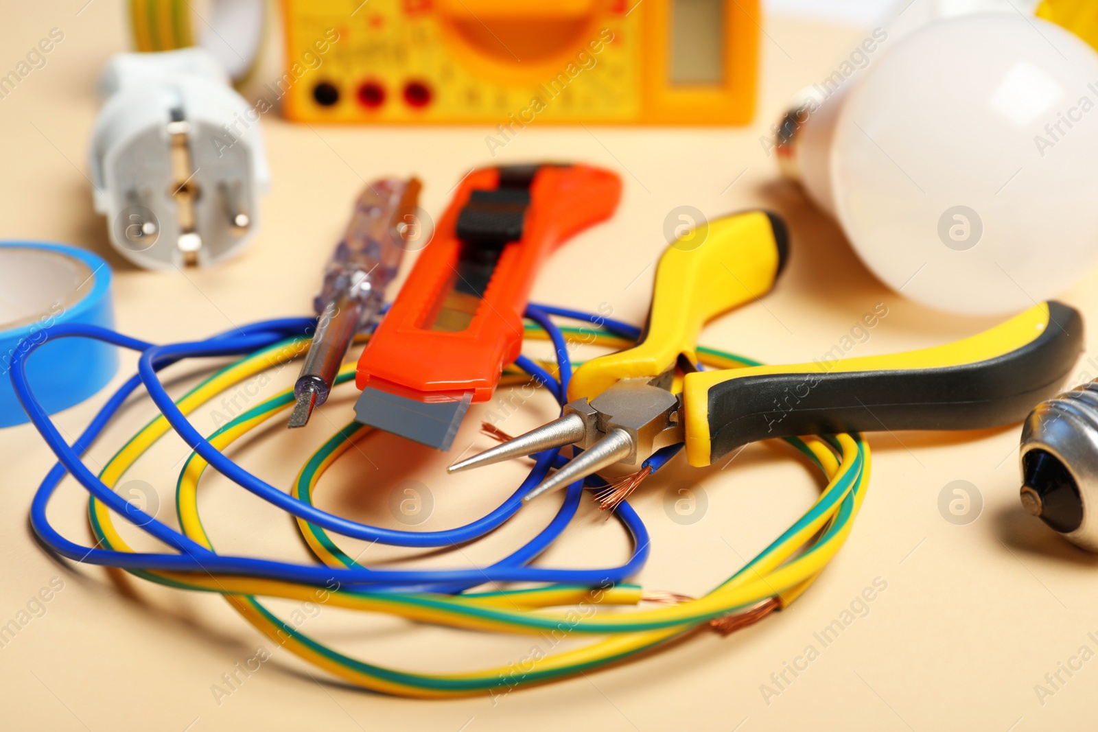 Photo of Set of electrician's tools on color background