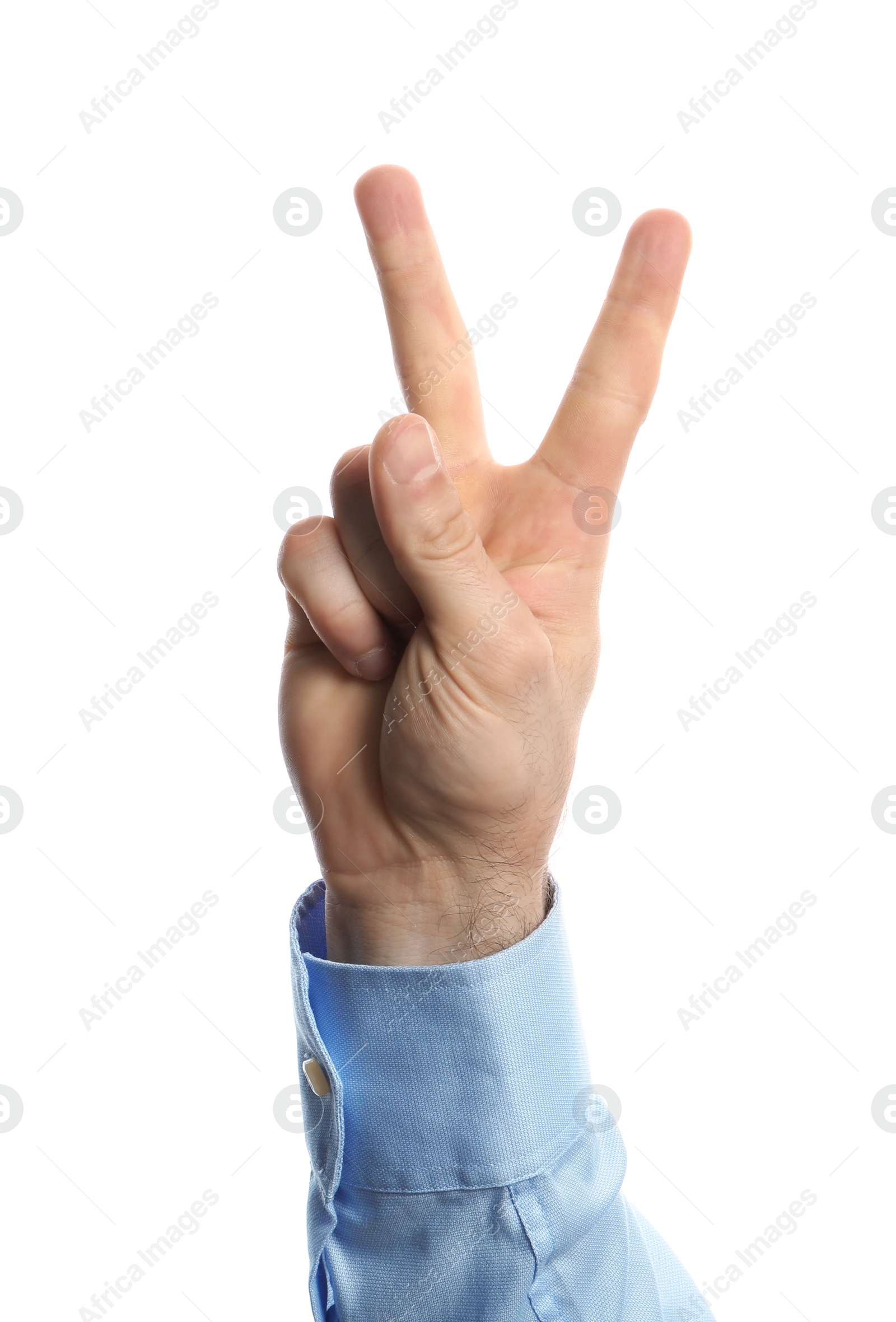 Photo of Young man showing victory gesture on white background