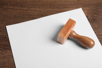 Blank sheet of paper and visa stamp on wooden table